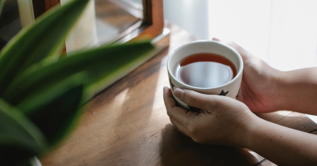 Working mom enjoying a peaceful moment with a cup of tea, embracing micro-moments of peace