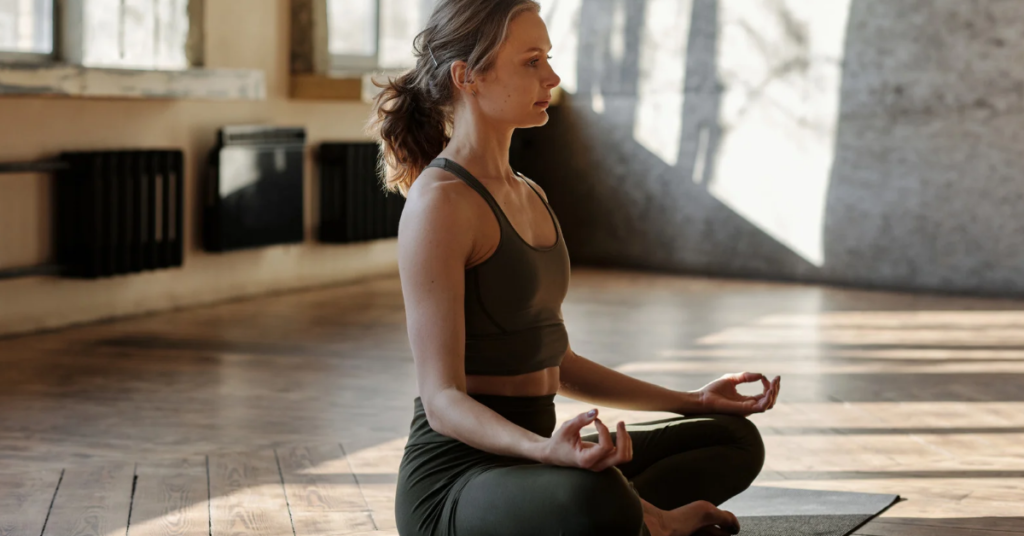 Busy woman using mindfulness practices and meditation to find inner peace and mental clarity.