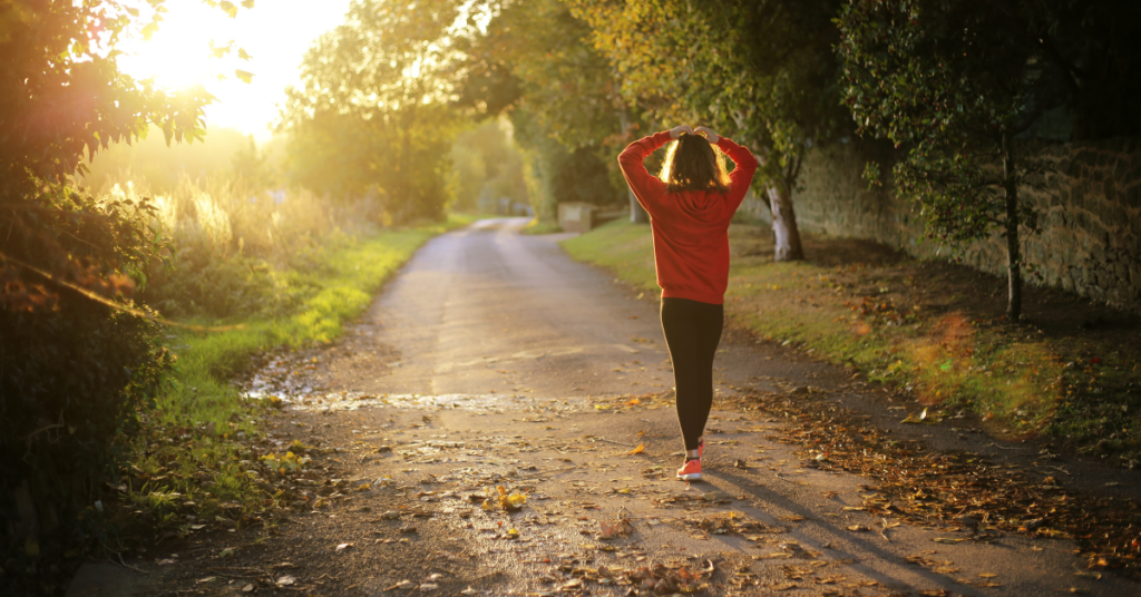 Woman walking a peaceful path, symbolizing the journey to self confidence and emotional healing.